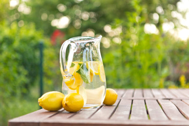 istock Fresh detox water with lemons on table in garden 1490593184