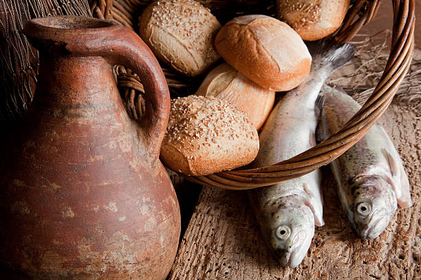 Old blessing Religious still life of 5 loaves of bread, an antique wine jug and 2 fish loaf of bread stock pictures, royalty-free photos & images