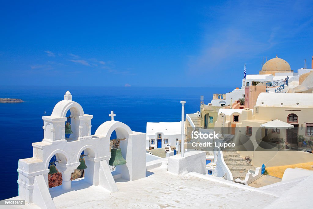 Looking at church bells and the ocean of Santorini Island Church bells on Santorini island, Greece Aegean Sea Stock Photo