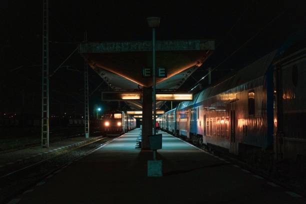 istock Night time urban landscape featuring a train station with several trains along the platform 1490597018