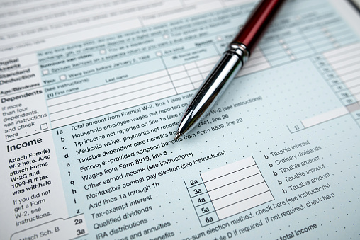 pen on blank 1040 Tax Return Form 2022. Deadline, paperwork