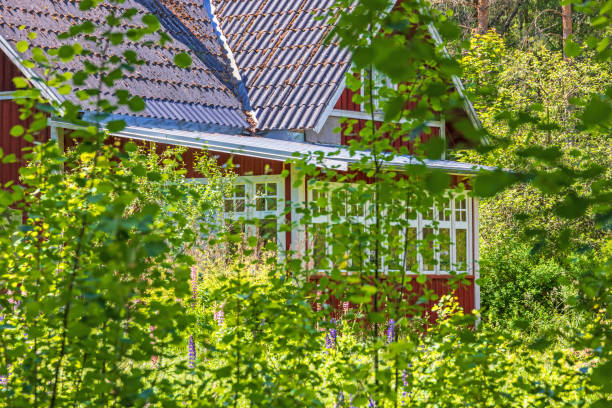 istock Red idyllic cottage with a veranda in a lush garden 1490598842