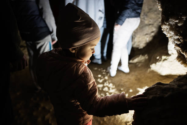 istock Baby girl walking in cave and explore it. 1490599826