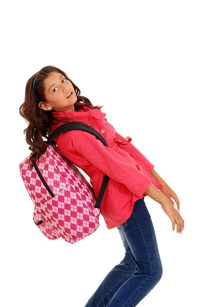 young school girl with heavy backpack isolated young school girl with heavy backpack person falling backwards stock pictures, royalty-free photos & images