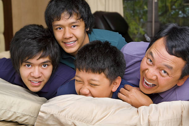 istock Father and sons having fun in bedroom 149060441