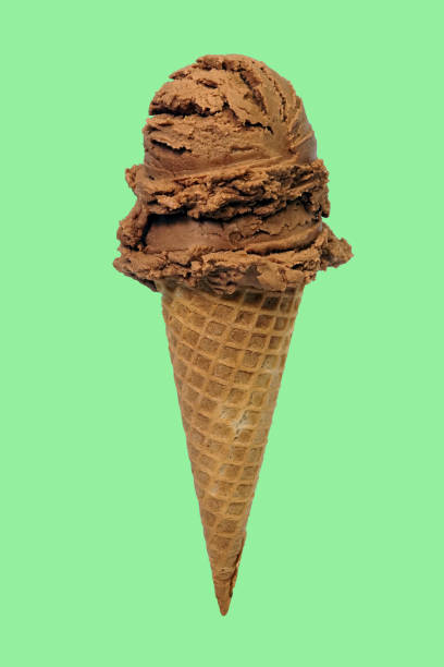 istock Scoops of chocolate ice cream in waffle cone on green background. 1490608364