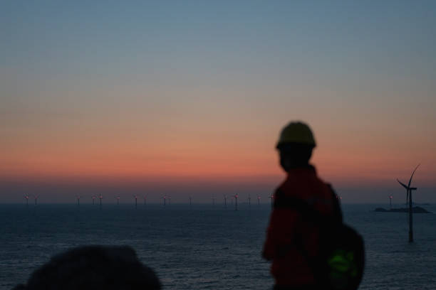 istock Romantic sky at an offshore wind farm at dawn 1490610902