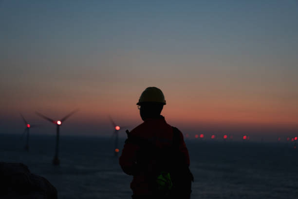 istock Romantic sky at an offshore wind farm at dawn 1490610909