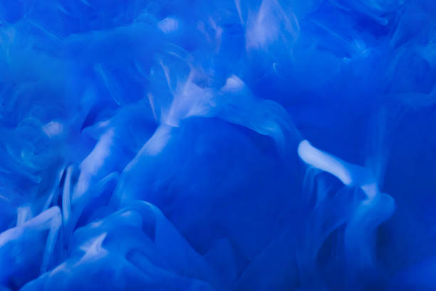 istock Fluid drop.Paint water.Paint splash.blue color ink smoke cloud floating on abstract art background.Blurred background. 1490611396