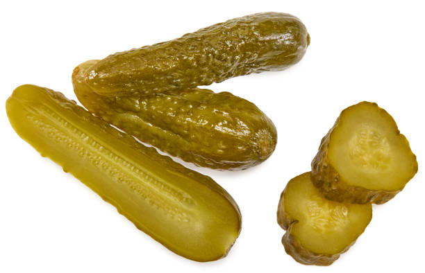 istock marinated pickled cucumbers with slices isolated on white background. Clipping path and full depth of field. Top view 1490612724
