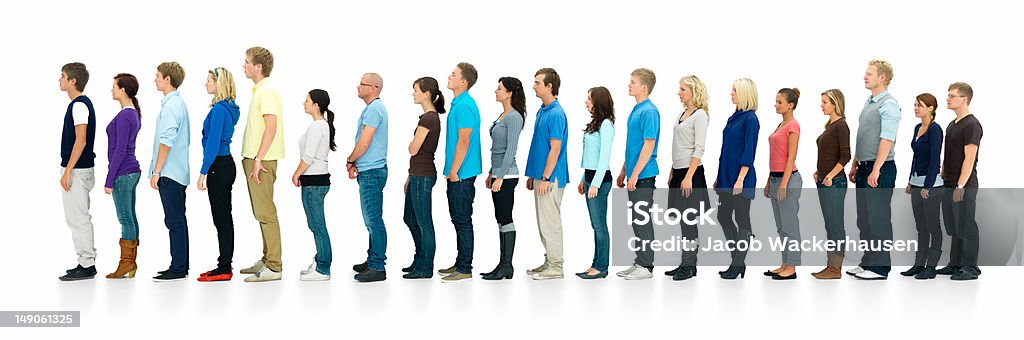 Young boys and girls standing in a line Young boys and girls standing in a line over white background Waiting In Line Stock Photo