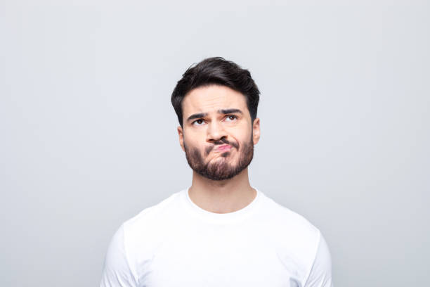 istock Headshot of confused young man 1490615027