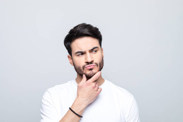 istock Headshot of confused young man 1490615071