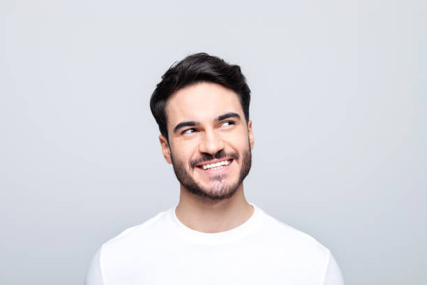 istock Headshot of happy young man looking away 1490615260