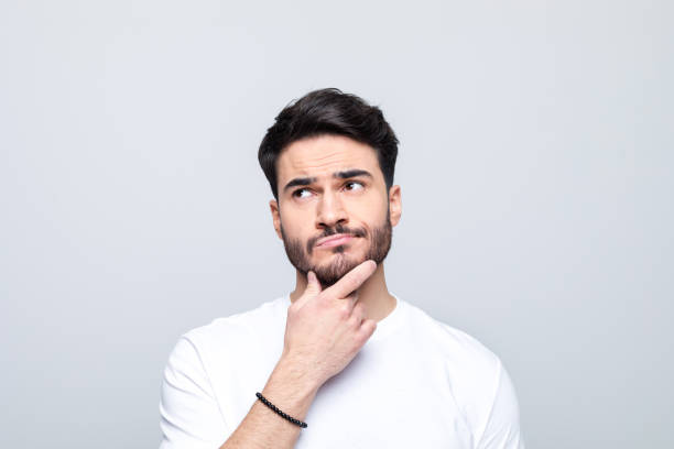 istock Headshot of thoughtful young man 1490615375