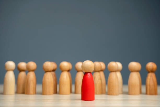 istock The red man steps forward from the group. Volunteer. Enterprising person. A special leader and promising head of the team. Courage, confidence and passion for new challenges. 1490616558