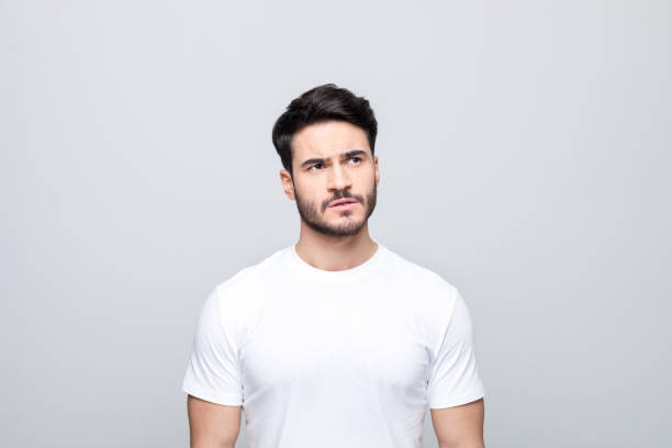 istock Portrait of thoughtful young man peeking 1490616811