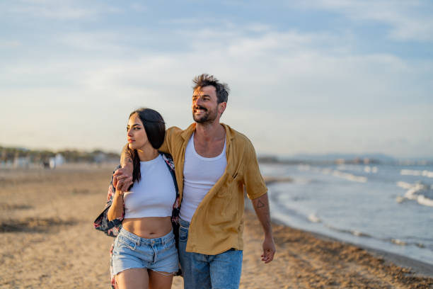 Affectionate young couple sharing an intimate moment at the beach