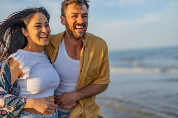 istock Young couple running on the beach 1490620854