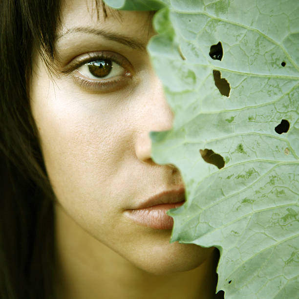istock beautiful girl with big leaves on head 149062088