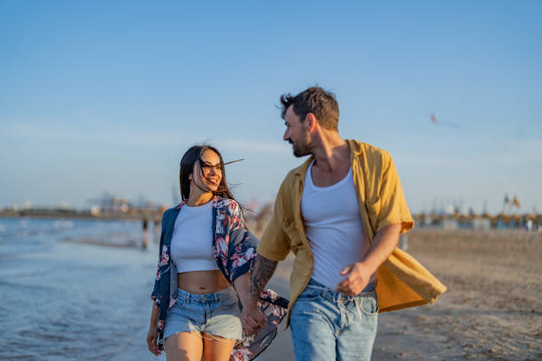 istock Young couple having fun at the beach together 1490620932