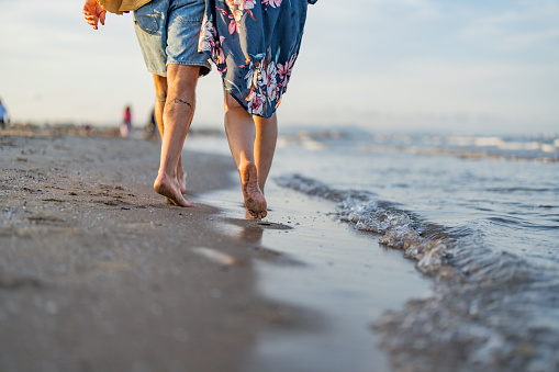 Couple taking a walk by the sea on a sandy beach