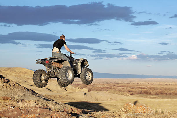Young man racing on a quad.