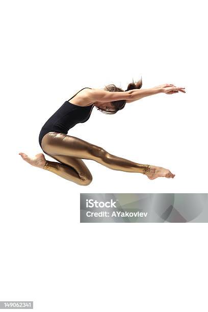 Woman Dancer With Black Top And Gold Pants Jumping Stock Photo - Download Image Now - Dancing, Modern, Acrobat