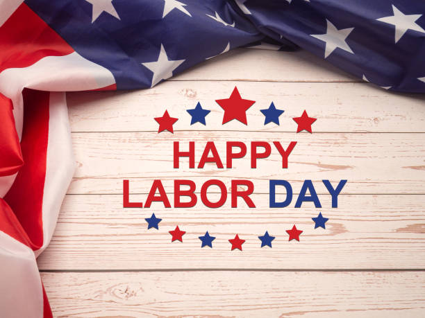 istock Happy labor day text over a wooden table and American Flag. 1490624356