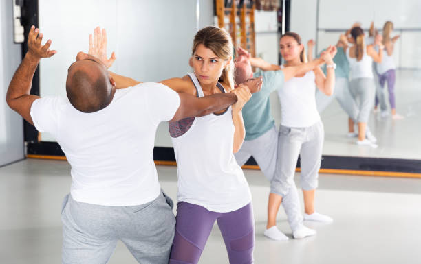 istock Woman performing palm heel strike while training in gym 1490625877