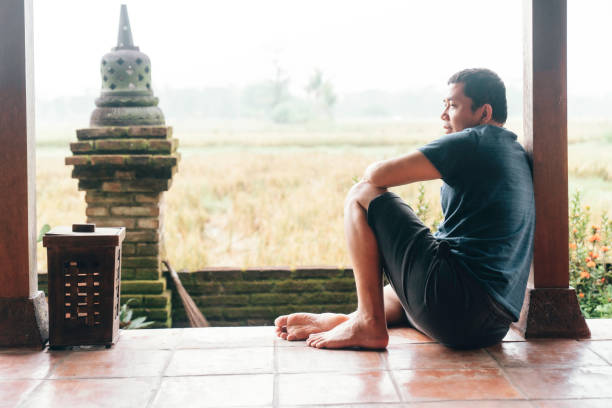 asian man sitting on patio