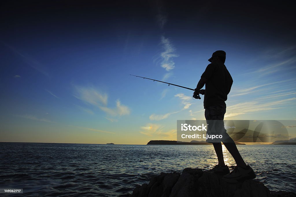 Fisherman no pôr-do-sol - Foto de stock de Pescaria royalty-free