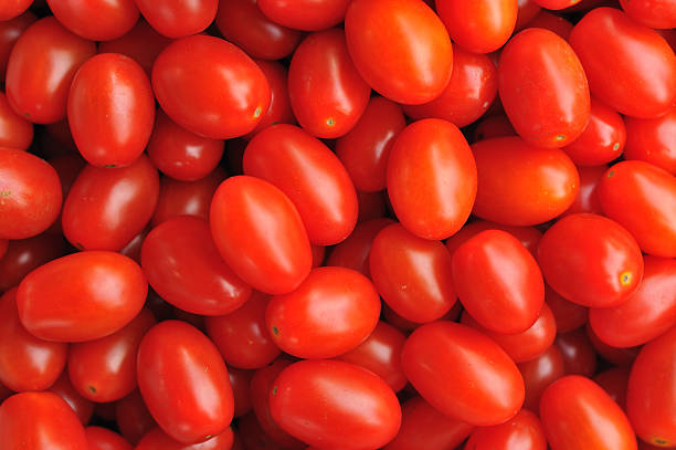 Grape Tomatoes A close up shot of a pile of grape tomatos grape tomato stock pictures, royalty-free photos & images