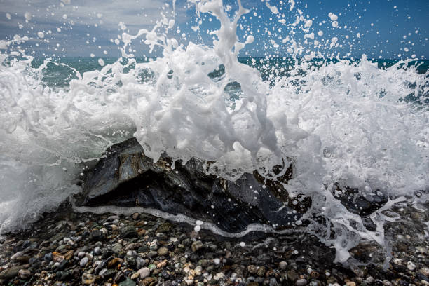 istock ocean with stones, sand, water and sun 1490628592