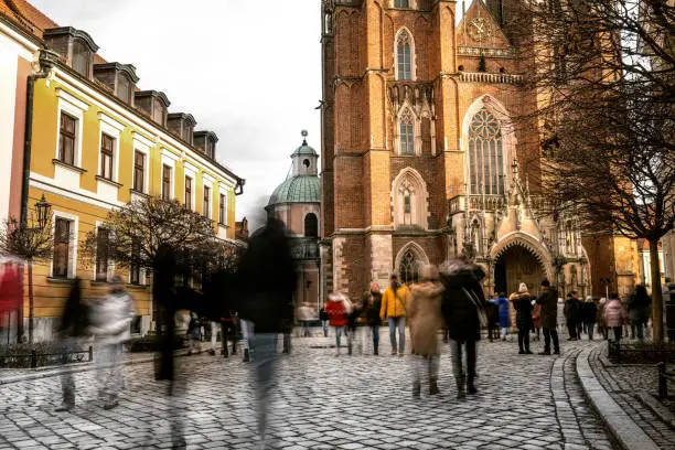 Photo of Tourists walking by Center historical streets of Wroclaw