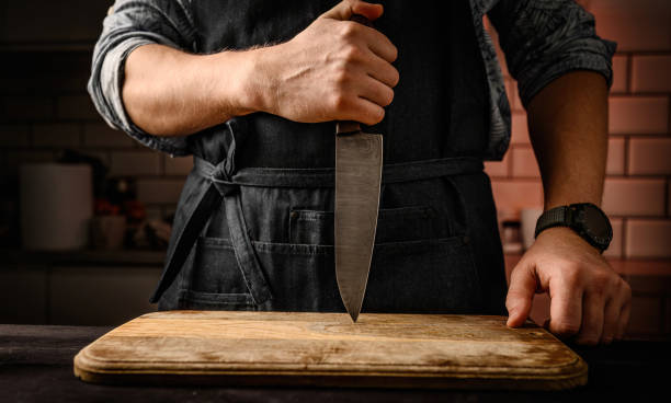 istock Chief man holding knife at kitchen 1490628784