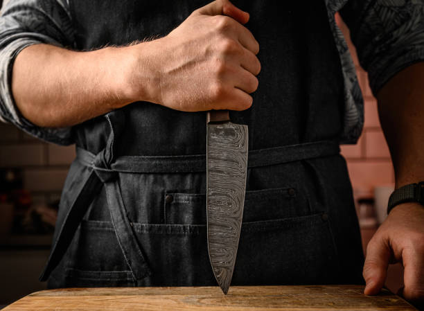 istock Chief man holding knife at kitchen 1490628795