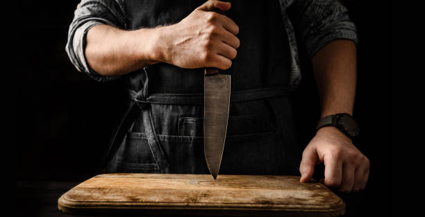 istock Chief man holding knife at kitchen 1490628857
