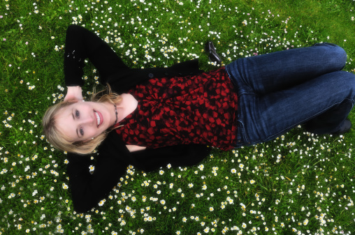 happy smiling woman in a field of daisies