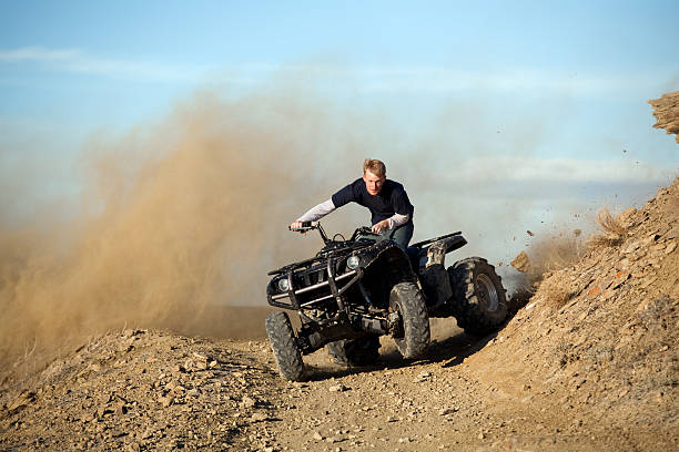 teen riding quad ATV in hills