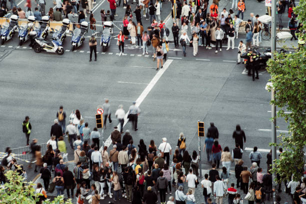 Crowd of people walking at zebra crossing.