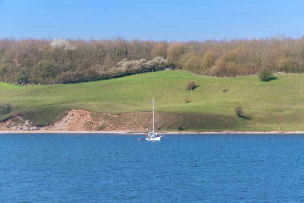 Sailboat Anchoring On River Trave Close To Travemuende