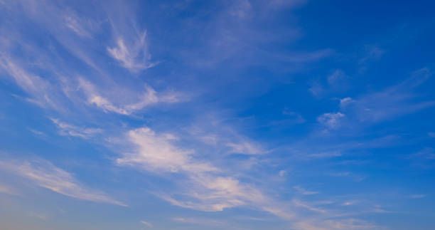istock Many white cirrus fluffy clouds in curve line pattern on blue sky background 1490633643