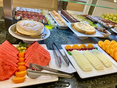 Buffet food selection of fresh produce and baked goods