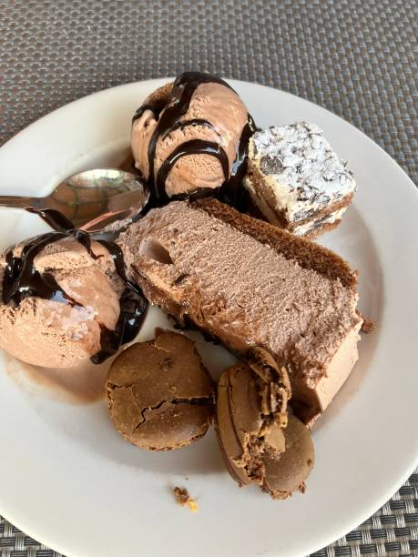 A plate of chocolate desserts: ice cream, cake, and sauces stock photo