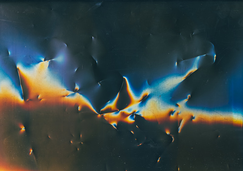 Weathered texture. Distressed film. Used surface. Blue orange color flare dust scratches noise on dark damaged uneven abstract illustration background.