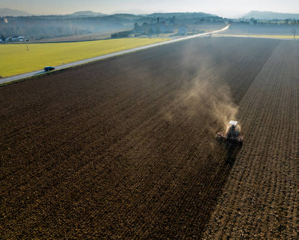 istock farmer driving a crawler tractor ploughing and power harrowing surface crust breaking to facilitate the birth and seeding of plants on dry soil 1490635010