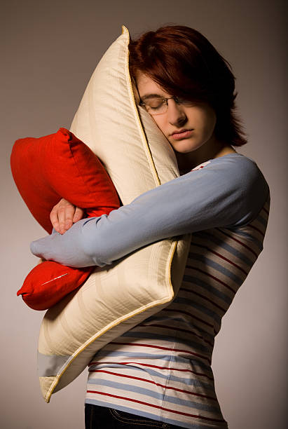 istock Girl hugs pillows 149063567