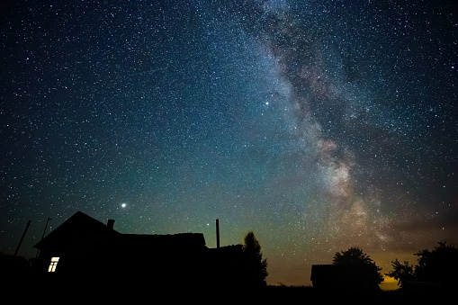 Night starry sky and milky way above countryside