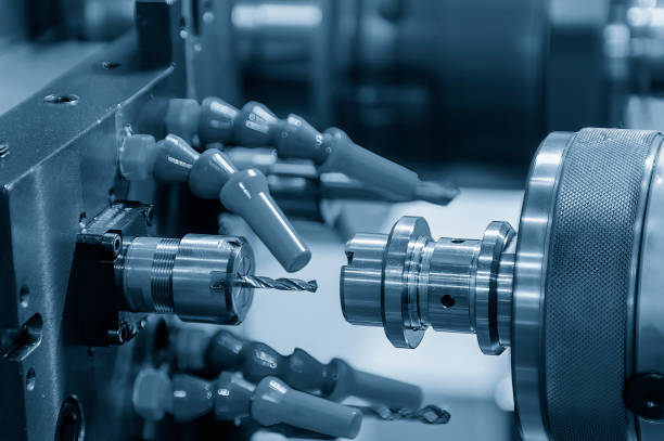 The  multi tasking CNC lathe machine  drilling the metal shaft parts. The  multi tasking CNC lathe machine  drilling the metal shaft parts. The hi-technology metal working processing by CNC turning machine . swiss machining stock pictures, royalty-free photos & images